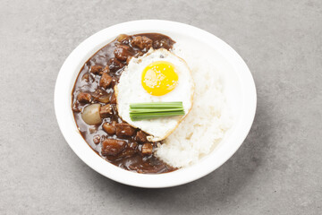 A food made by frying meat, potatoes, pumpkin, and onions in Chinese soybean paste and putting the sauce on top of rice.