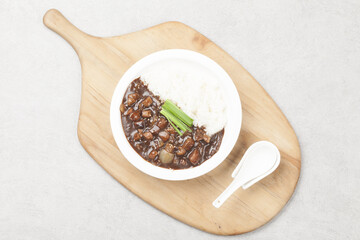 A food made by frying meat, potatoes, pumpkin, and onions in Chinese soybean paste and putting the sauce on top of rice.