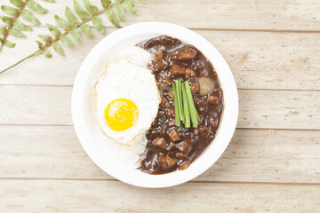 A food made by frying meat, potatoes, pumpkin, and onions in Chinese soybean paste and putting the sauce on top of rice.