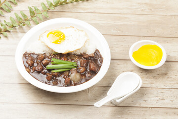 A food made by frying meat, potatoes, pumpkin, and onions in Chinese soybean paste and putting the sauce on top of rice.