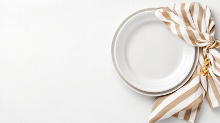Minimalist Table Setting: Two pristine, light-colored plates are paired with a stylish striped cloth, creating a clean and inviting setup.
