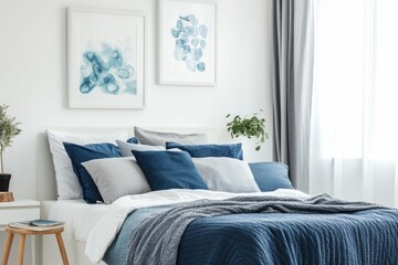 Serene bedroom with blue bedding, grey accents, and abstract art.