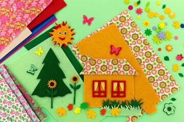 Composition of felt crafts. Felt crafts on a pleasant green background. Spring and summer mood.