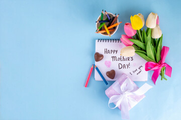 Mother day greeting card, brunch or party invitation background, Spring bouquet of tulip flower, with gift bow and note Happy Mothers day, copy space on colorful light blue background