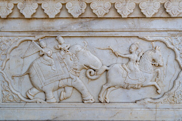 India. Rajasthan. Jaipur. Gatore Ki Chhatriyan. Magnificent marble memorial dedicated to Maharaja Sawai Mansingh II and his family. Bas relief representing Maharadjas on elephants