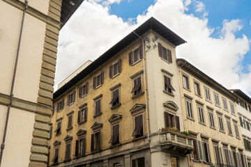 A very large building that has an abundance of windows on a sunny day