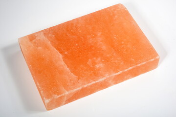 A pinksalt cooking slab  cooking tool made of natural rock salt. Hymalayan pink salt block on white background 