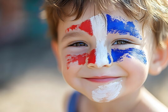 Happy toddler with a painted face, red blue and white representing a flag