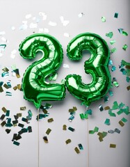 Green balloon number 23 for twenty-third birthday or anniversary party. White background with confetti