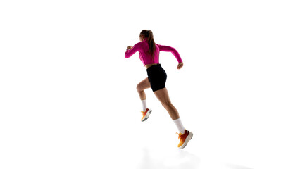 Low angle back view image of young sportive woman, running athlete in motion, training isolated on white studio background. Concept of athletics, sport, endurance, fitness, healthy lifestyle. Ad