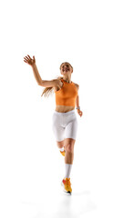 Joyful female runner in motion, sprinting forward with energy, smiling confidently, embracing speed and power against white studio background. Concept of victory, determination, action.