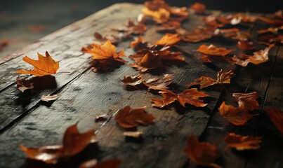 Freshly fallen autumn leaves scattered on a wooden table, soft natural light creating a warm seasonal visual