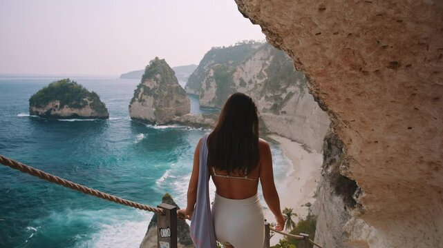 woman walks down the stairs to Diamond Beach on Nusa Penida