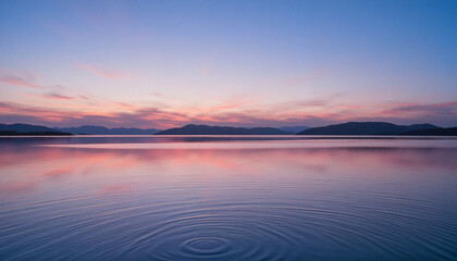 Obraz premium Tranquil lake reflecting soft pink and blue sunset colors, peaceful atmosphere for Stress Awareness Month banner