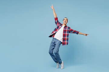 Full body young middle eastern man he wear red shirt casual clothes standing on toes dancing lean...