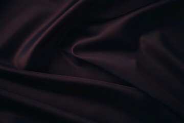 Fototapeta premium close-up of luxurious deep red fabric with silky texture and dynamic folds for elegant design