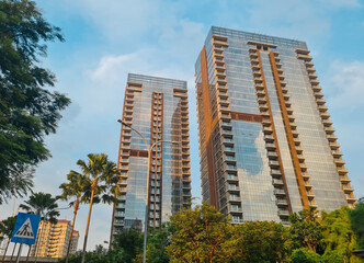 Obraz premium low angle view of Jakarta modern office building with glasses window. Glass building tower of modern architecture. Glass facade.