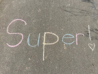A motivational message on the sidewalk in chalk, saying Super a great visual for promoting physical...