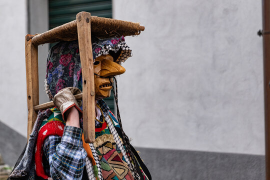 Shignano (Italy) 03/01/23: The carnival of Schignano parade is one of the most famous traditional carnivals of north Italy with typical wood masks and performer that entertain the visitors .