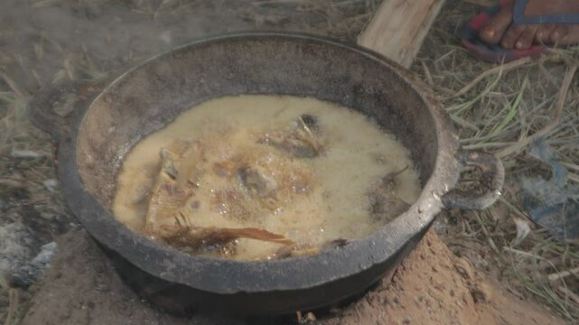 African Woman frying fish
