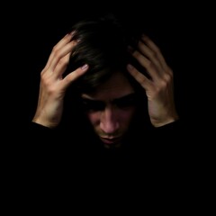 Distressed Student with Intense Expression Showing Exam Anxiety Against Dark Background