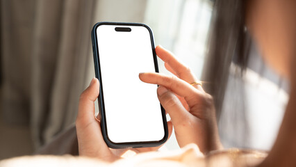 Close up of Woman hand holding using touch mobile phone white screen mockup. Back view