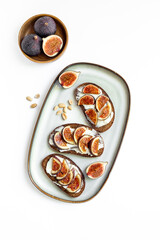 Top view of breakfast table with fig, cheese and honey sandwiches