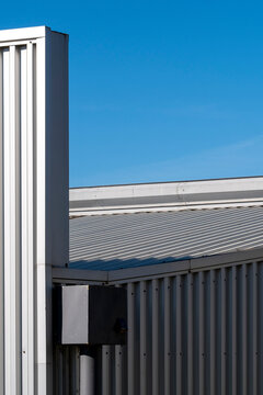 Industrial building with corrugated metal facade, highlighting functional architecture and urban industrial aesthetics.