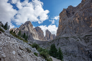 Majestic Dolomites landscape showcasing rocky peaks and lush greenery under a bright sky