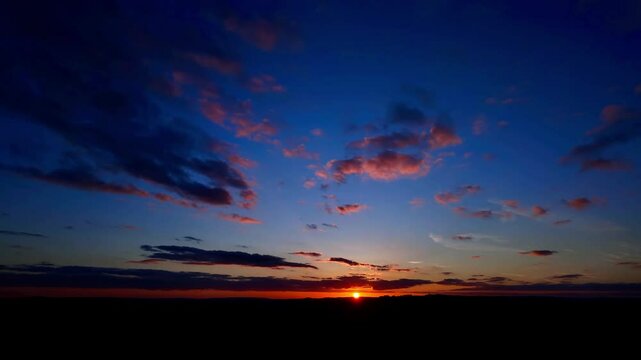 Landscape scene of Sunset sky with moving clouds over Bamford Edge, Derbyshire, UK