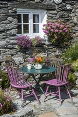 Fototapeta premium Quaint Stone Cottage Garden Scene with Colorful Flowers and Rustic Furniture in a Serene Outdoor Setting