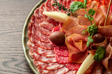 Meat antipasto platter salami, sliced ham, sausage, prosciutto. Top view