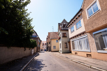 Charming European Village Street Scene with Traditional Architecture Under Clear Skies