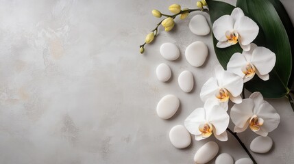 Mindfulness and meditation wellness concept: top view of spa or wellness design elements with orchid and pebbles elements on light grey background, flat lay with space for text.