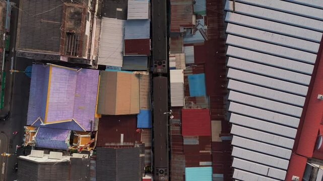 Moving train crossing Maeklong Railway Market, offering an exciting and exotic glimpse of local commerce in Thailand