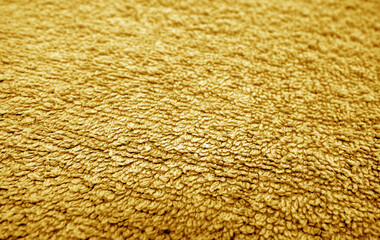 Orange bath towel surface and texture close up with blur effect.