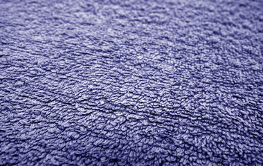 Blue bath towel surface and texture close up with blur effect.