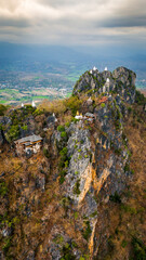vertical Aerial view of Thailand Sky Temple, Wat Chaloem Phra Kiat is Buddhist Temple which has been built at the very top of a mountain peak in Lampang 