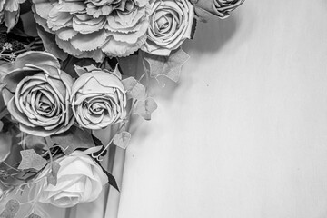 Monochrome artificial floral bouquet with dramatic lighting, vintage black and white photography concept