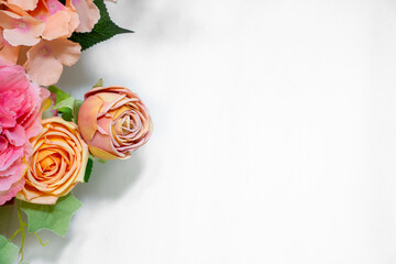 A stunning floral arrangement featuring yellow and pink roses with lush green leaves on a clean white background, ideal for weddings and elegant event decorations