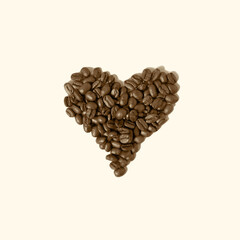 Heart of coffee beans isolated on bright background.. Creative love coffee concept.
