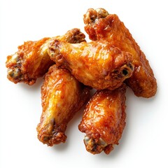 Delicious golden brown fried chicken wings glistening with sauce on a clean white surface top down view