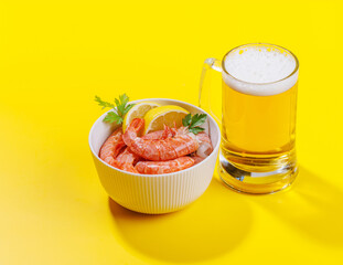 A vibrant photo showcasing a glass of beer and fresh shrimps