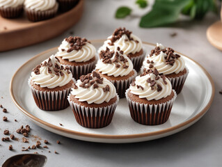 Chocolate cupcakes with rich buttercream frosting and chocolate shavings on top.