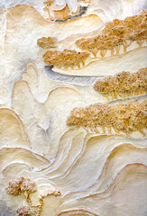 Beautiful wall relief engraving painted in gold, white, and grey mural paint. Chinese wall murals depicting mountain, waterfall, river, bridge, pagoda, and bonsai trees. Chinese mountain landscape scu