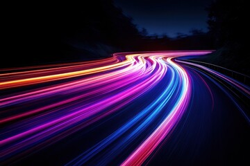 Dynamic light trails illuminate winding road at night creating vibrant streaks of color and motion for futuristic concept