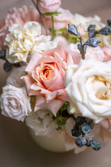 Delicate composition of white and pink roses in a basket