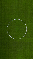 Aerial view of a Sports field in a residential area with artificial green grass and football goal in Santo Tirso, Portugal. Soccer pitch center top view background.
