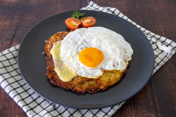 Swiss national dish. Roesti, a potato cake served with Swiss cheese and fried egg.