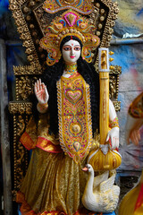 Clay idol of Goddess Saraswati being crafted for Saraswati Puja at a pottery studio in West Bengal, India